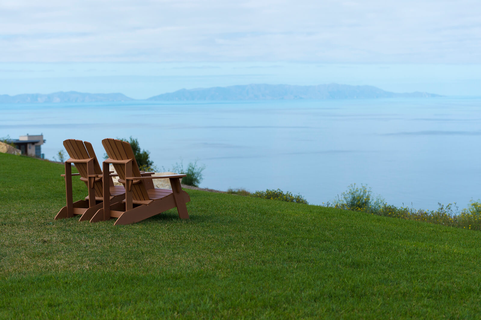 chairs on grass overlooking the ocean